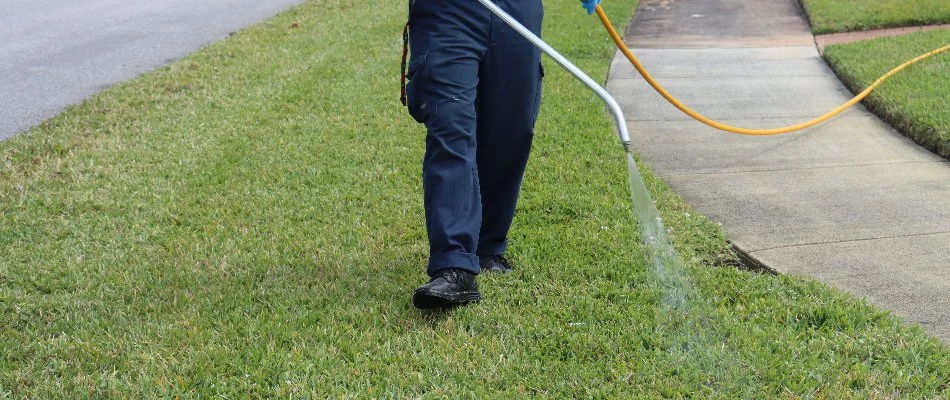 Crew spraying lawn care treatment in Broward County, FL.