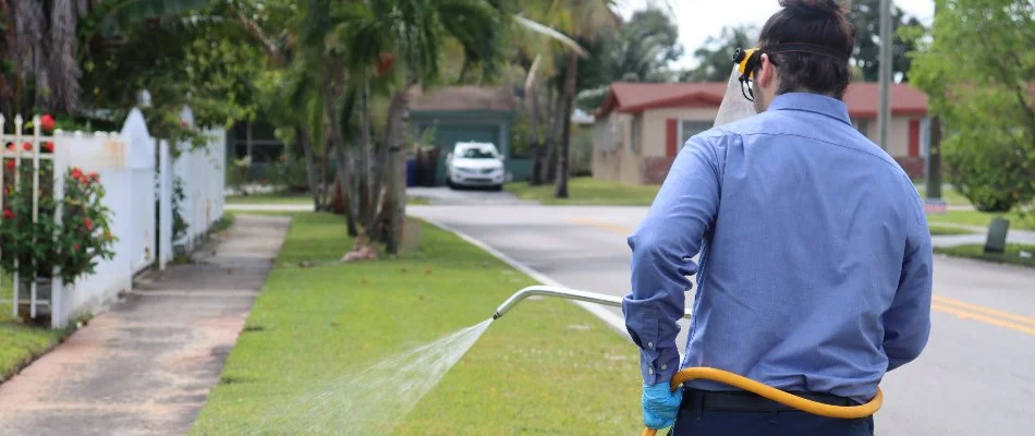 Crew treating a lawn in Brownsville, FL, with fertilizer.