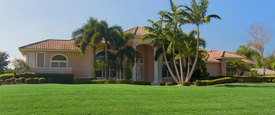 Home in Cooper City, FL, with healthy, green grass.