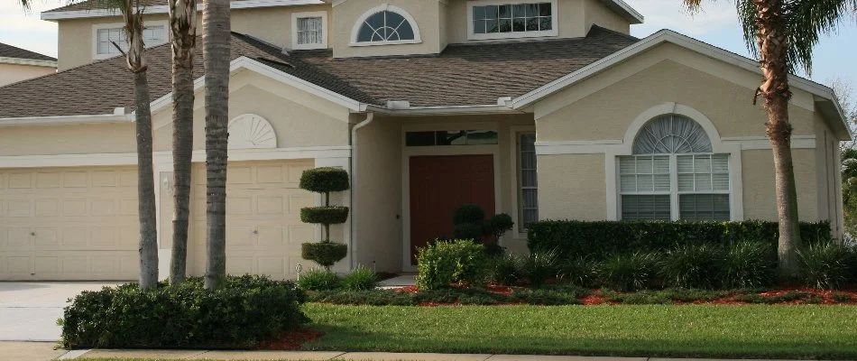 Front yard of a house in North Miami Beach, FL, with trees and shrubs.