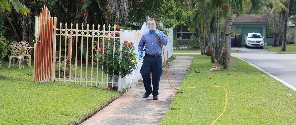 A lawn care professional applying a treatment onto a lawn in Deerfield Beach, FL.