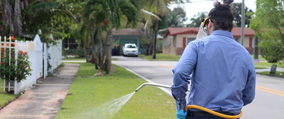 Professional spraying lawn fertilizer treatment in Miramar, FL.