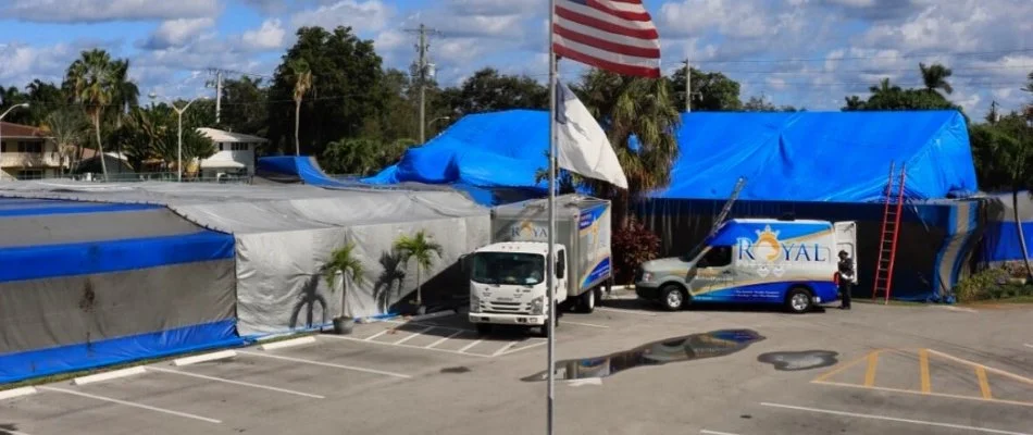 Trucks and tent in North Miami Beach, FL, during fumigation for termite control.