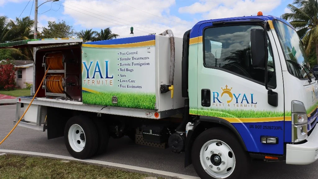 Royal Pest & Termite truck with a yellow lawn care hose.
