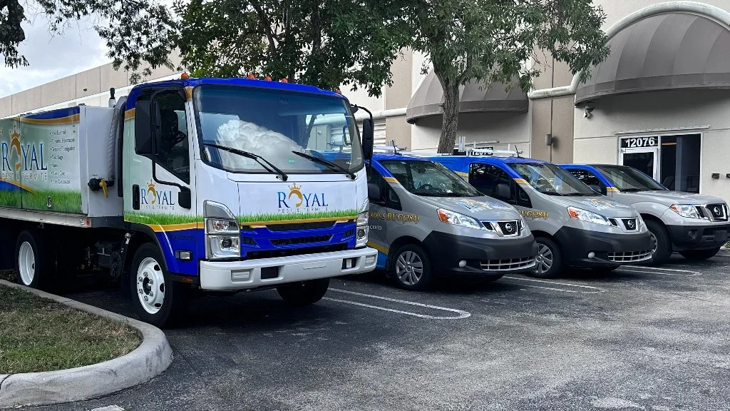 Royal Pest & Termite trucks in parking lot.